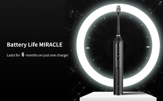 Image of black electric toothbrush in front of light